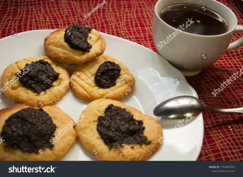 stock-photo-bitten-cookies-with-poppy-seed-filling-and-coffee-in-daylight-bakery-background-1754387483